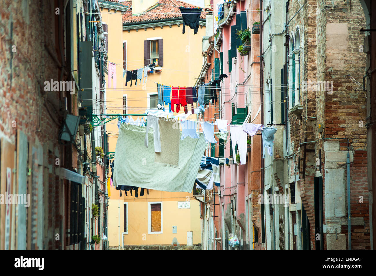 Typical street in Venice, Italy with clothes hanging out to dry in-between houses Stock Photo