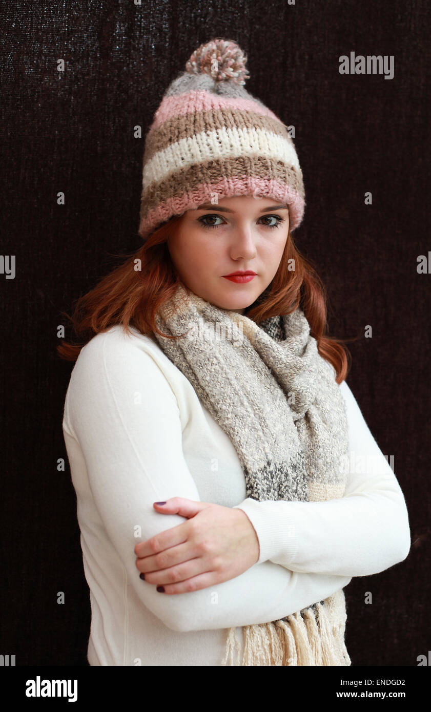 Portrait of a pretty teenage girl with red hair all wrapped up against the cold Stock Photo