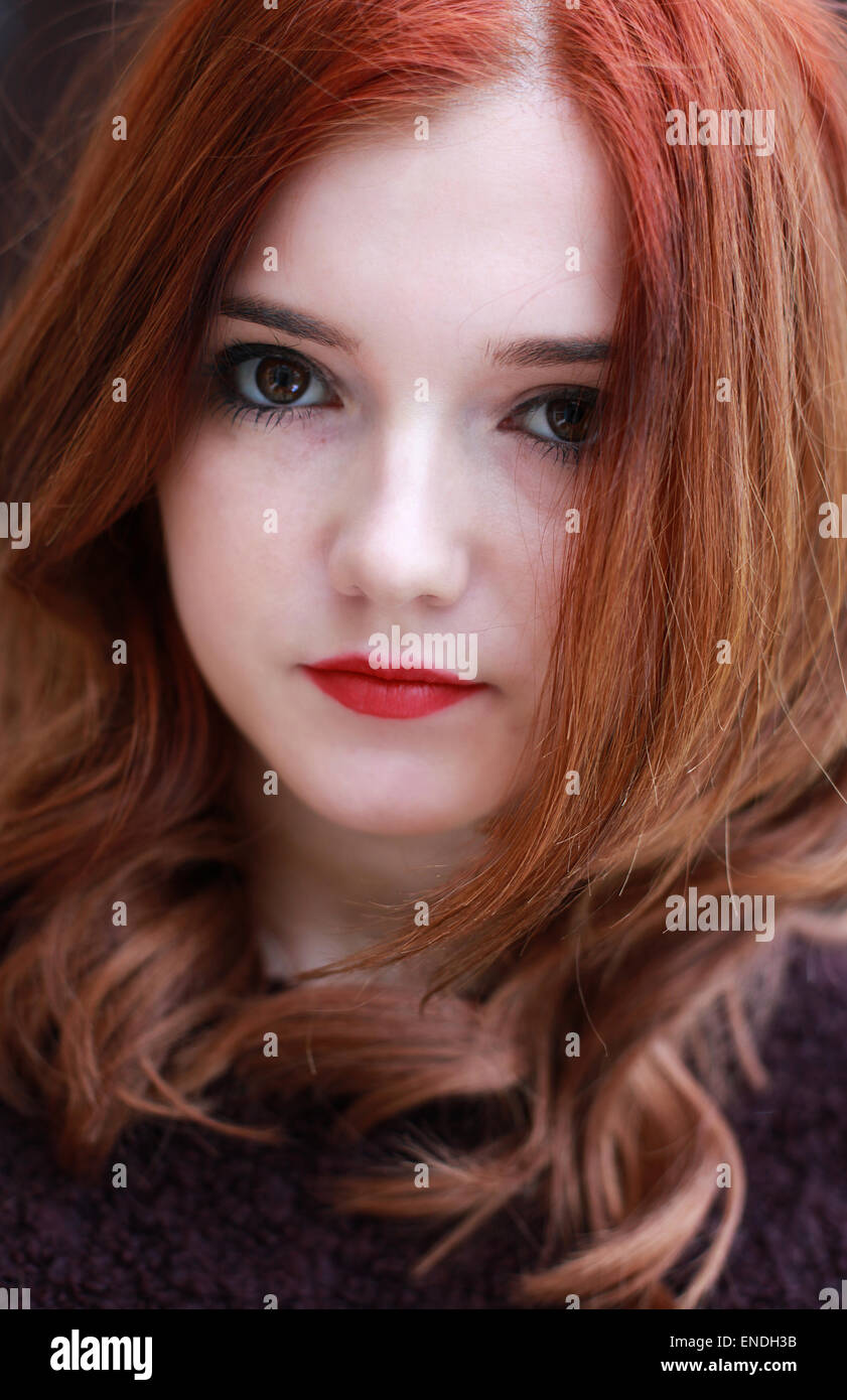 Portrait of a pretty teenage girl with red hair looking straight to camera Stock Photo