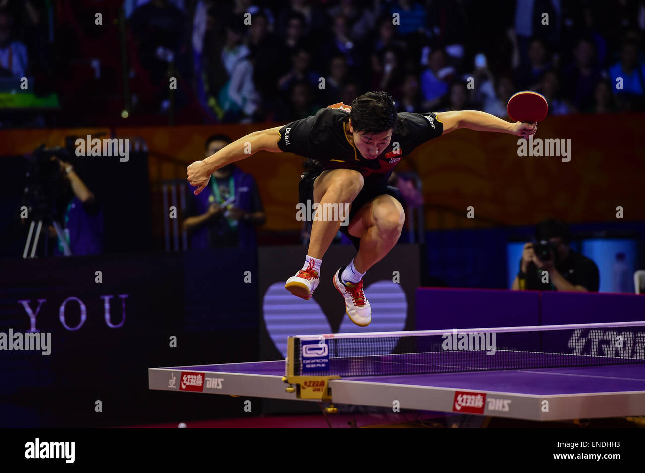 Suzhou, China's Jiangsu Province. 2nd May, 2015. China's Ma Long jumps onto the table for celebration after Men's Singles Final against his compatriot Fang Bo at the 53rd Table Tennis World Championships in Suzhou, city of east China's Jiangsu Province, on May 2, 2015. Ma Long won 4-2 and claimed the title. Credit:  Jing Changchun/Xinhua/Alamy Live News Stock Photo