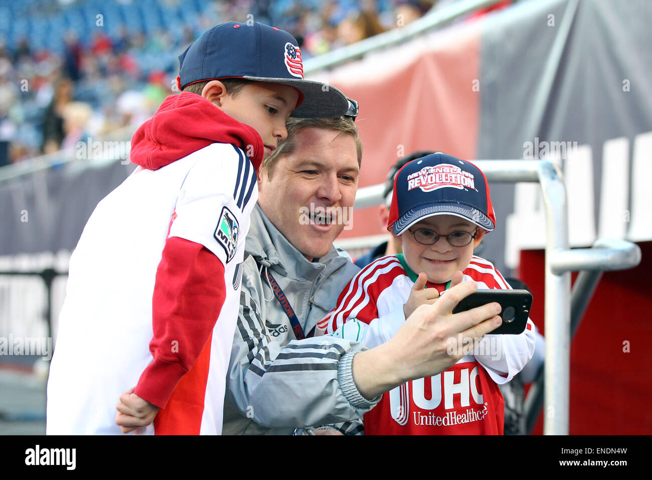 Foxborough, MA, USA. 2nd May, 2015. New England Revolution Director of Marketing Cathal Conlon (center) takes a selfie with Leukemia survivor Liam Fitzgerald (right) prior to the MLS game between the New England Revolution and New York Red Bulls at Gillette Stadium. New England defeated New York 2-1. Anthony Nesmith/CSM Stock Photo