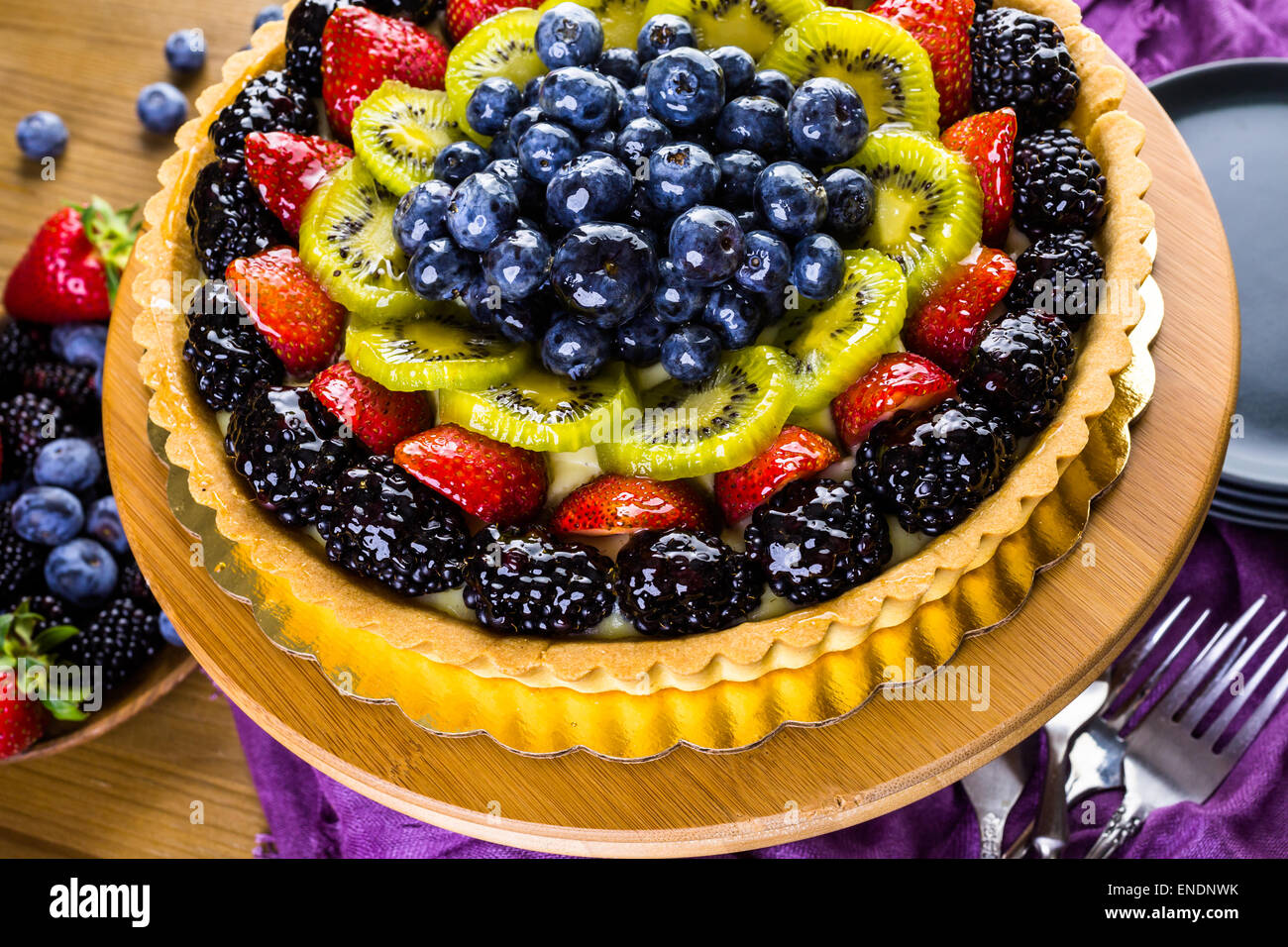 Fresh fruit tart on cake stand on wood table Stock Photo - Alamy