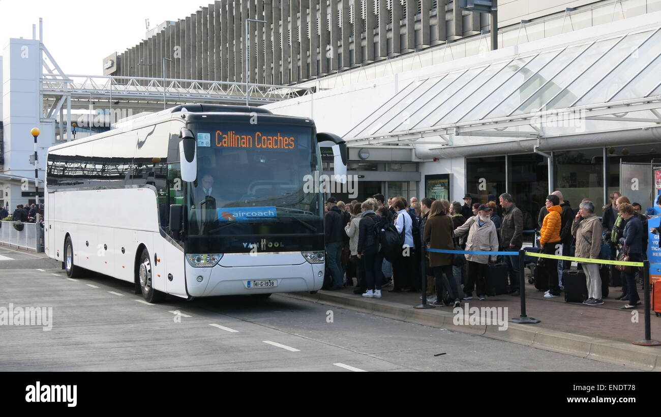 A large crowd stands outside an alternative transport Aircoach bus at Dublin airport during a day of Dublin Bus strike action Stock Photo