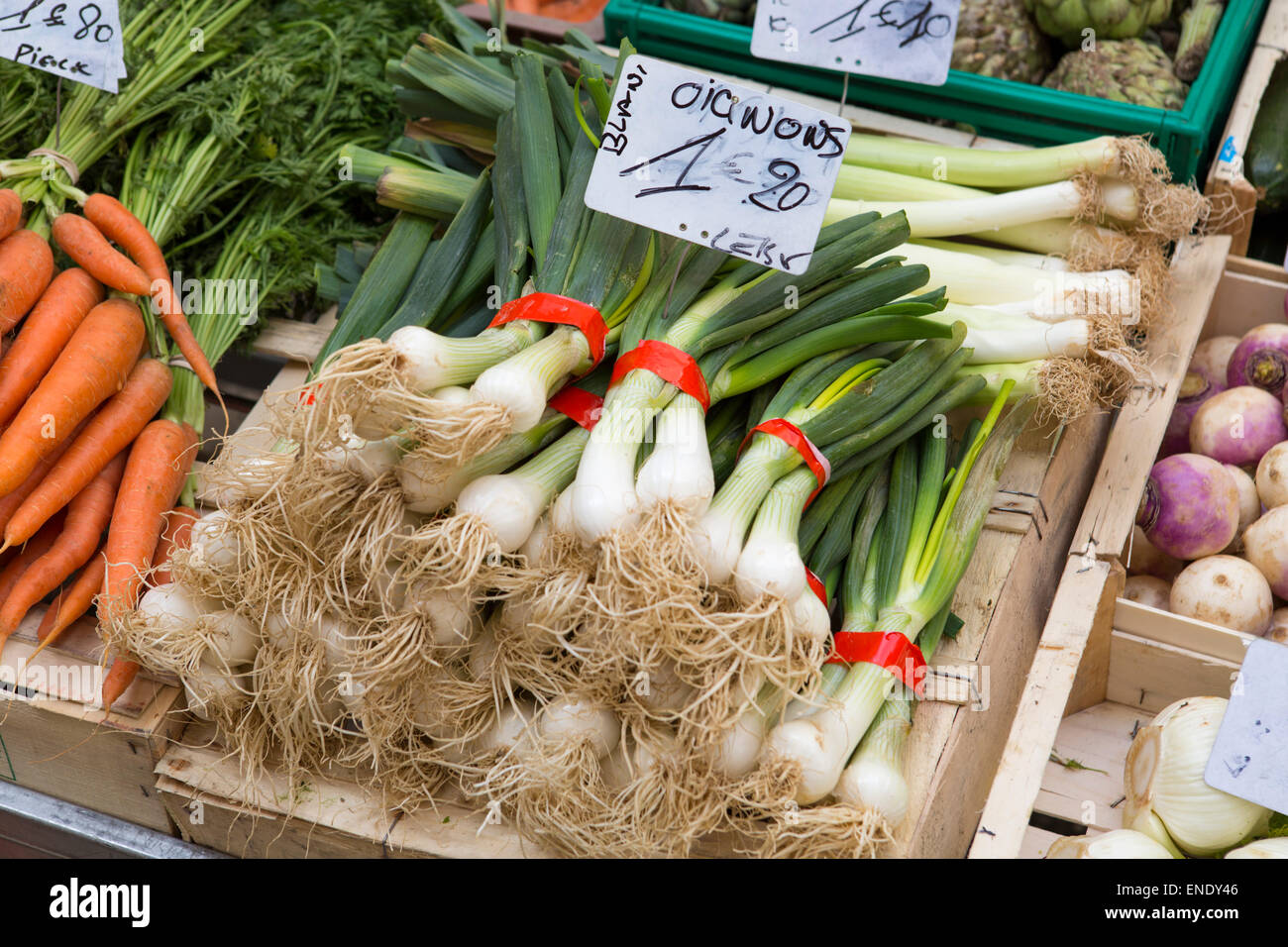 Close up of white onions at the local market with local vegetables food products in France Stock Photo