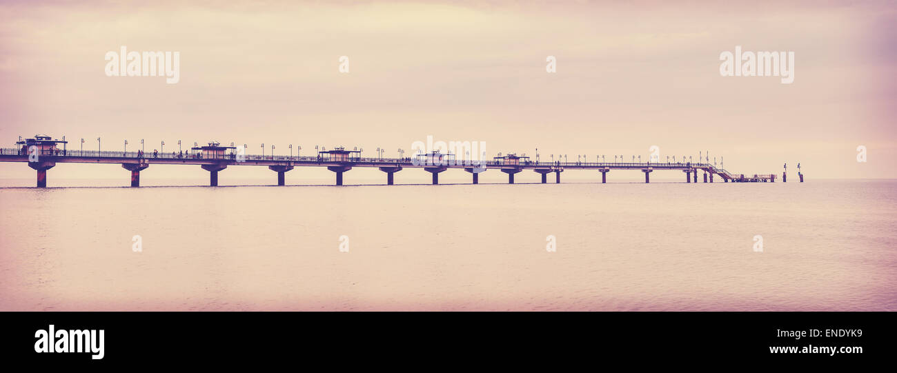 Retro vintage filtered picture of long pier in Miedzyzdroje, Poland. Stock Photo