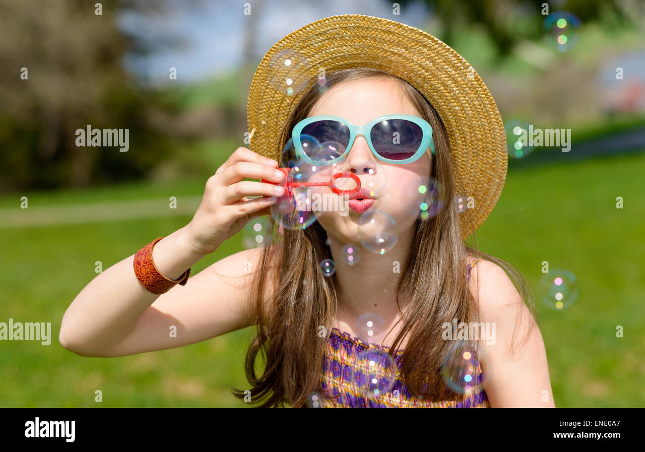 a little girl making soap bubbles in nature Stock Photo - Alamy