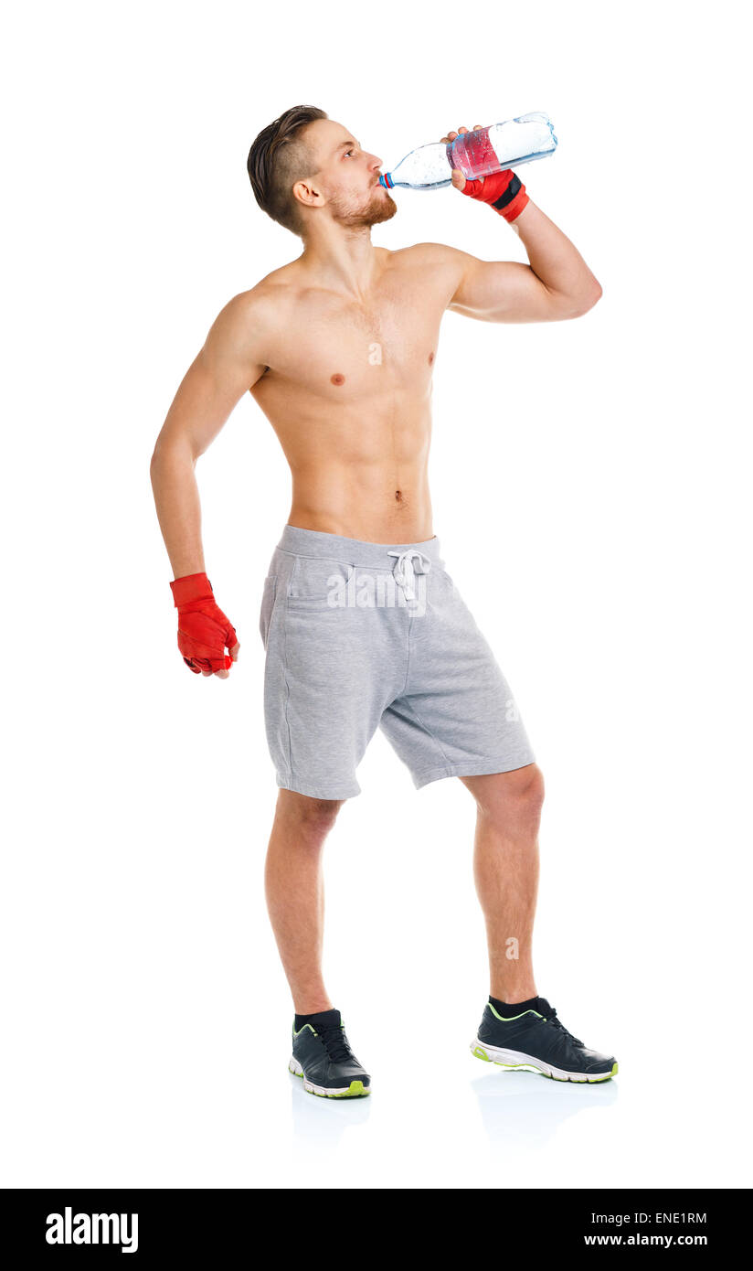 Sport attractive man wearing boxing bandages and drinking fresh water on the white background Stock Photo