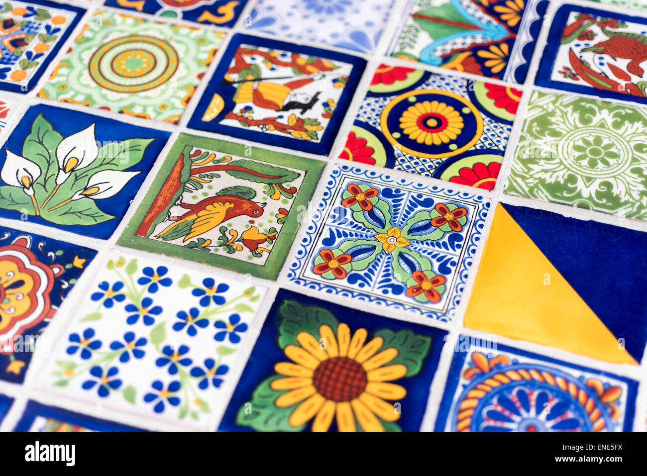 Mosaic assortment of Mexican hand painted tiles in pottery shop Stock Photo