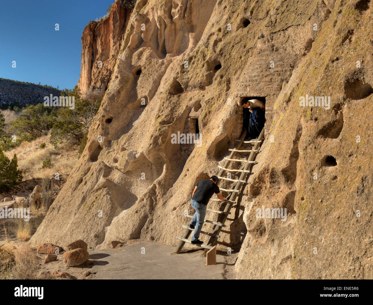 Two tourists explore one of the cliff dwellings at Bandelier National Monument, near Los Alamos, New Mexico Stock Photo