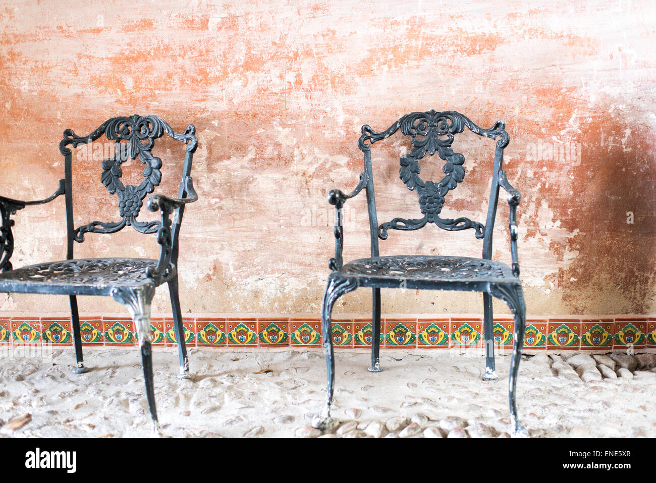 Two ornate iron chairs on patio at Hacienda Las Trancas in Mexico Stock Photo