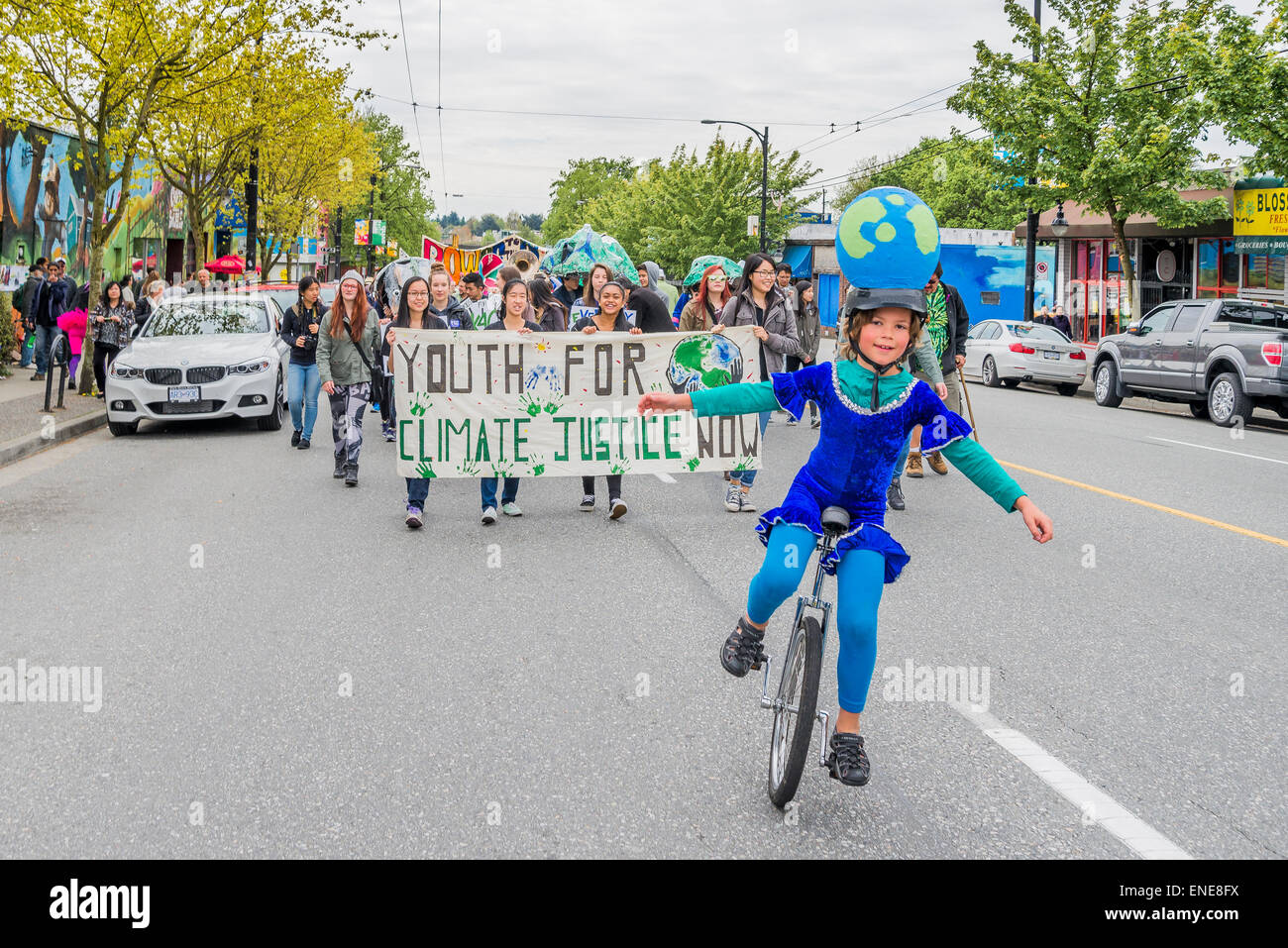 Boy on unicycle, leads Earth Day Parade , Commercial Drive, Vancouver
