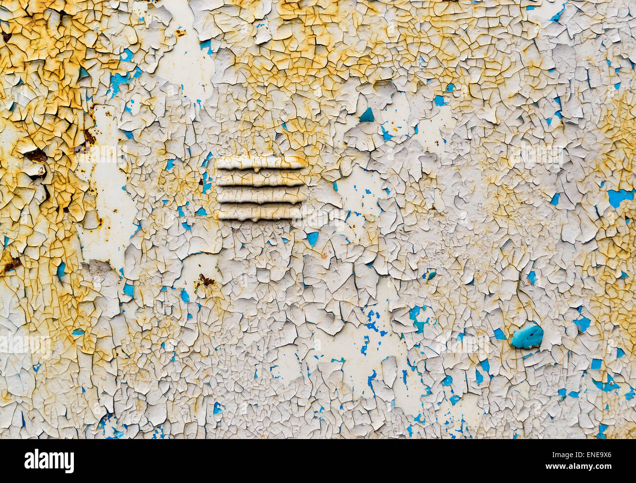 White paint on metal with cracks and flakes revealing a bright blue undercoat Stock Photo Alamy