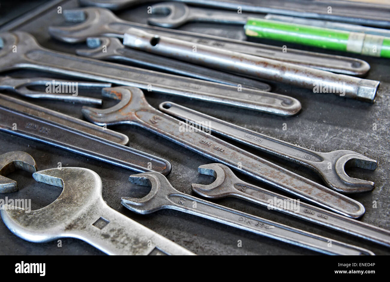 Still Life Close Up of Collection of Well-Used Metal Wrenches in Variety of Sizes on Work Tray Stock Photo