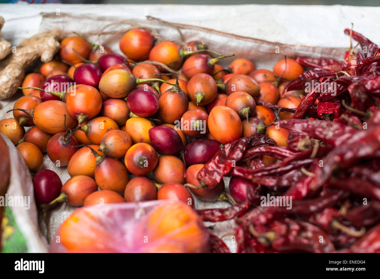 Yellow passion fruit and red chili peppers at weekend covered market in Thimphu, Bhutan, Asia Stock Photo