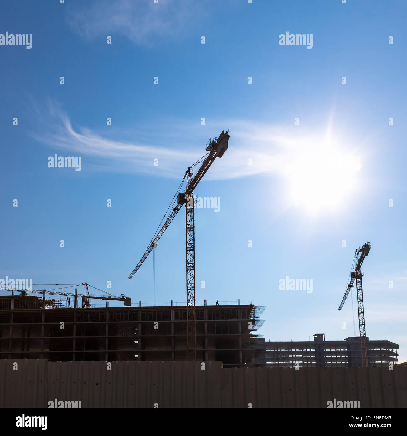 Construction cranes on building site on sky background Stock Photo - Alamy