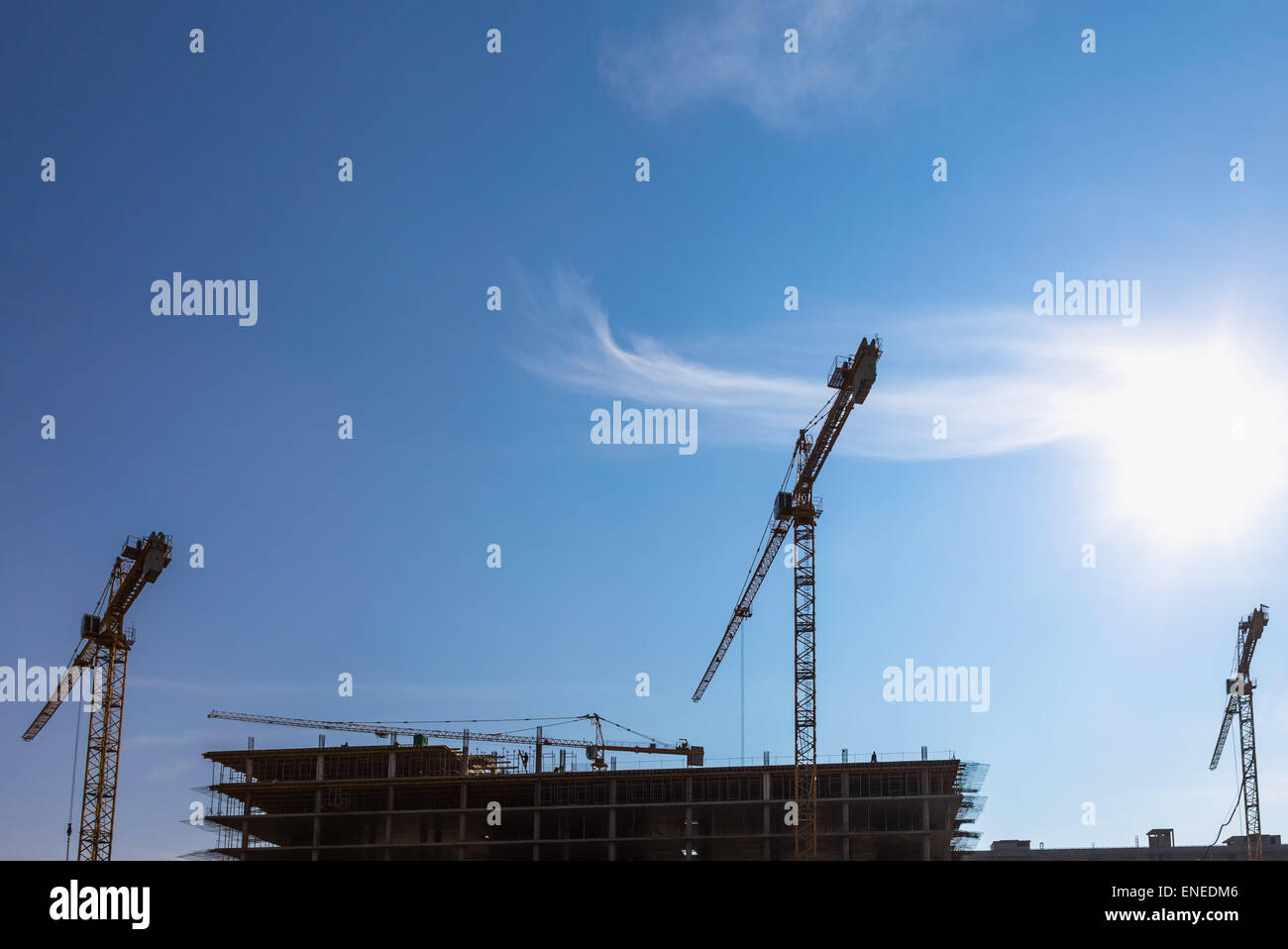 Construction cranes on building site on sky background Stock Photo - Alamy