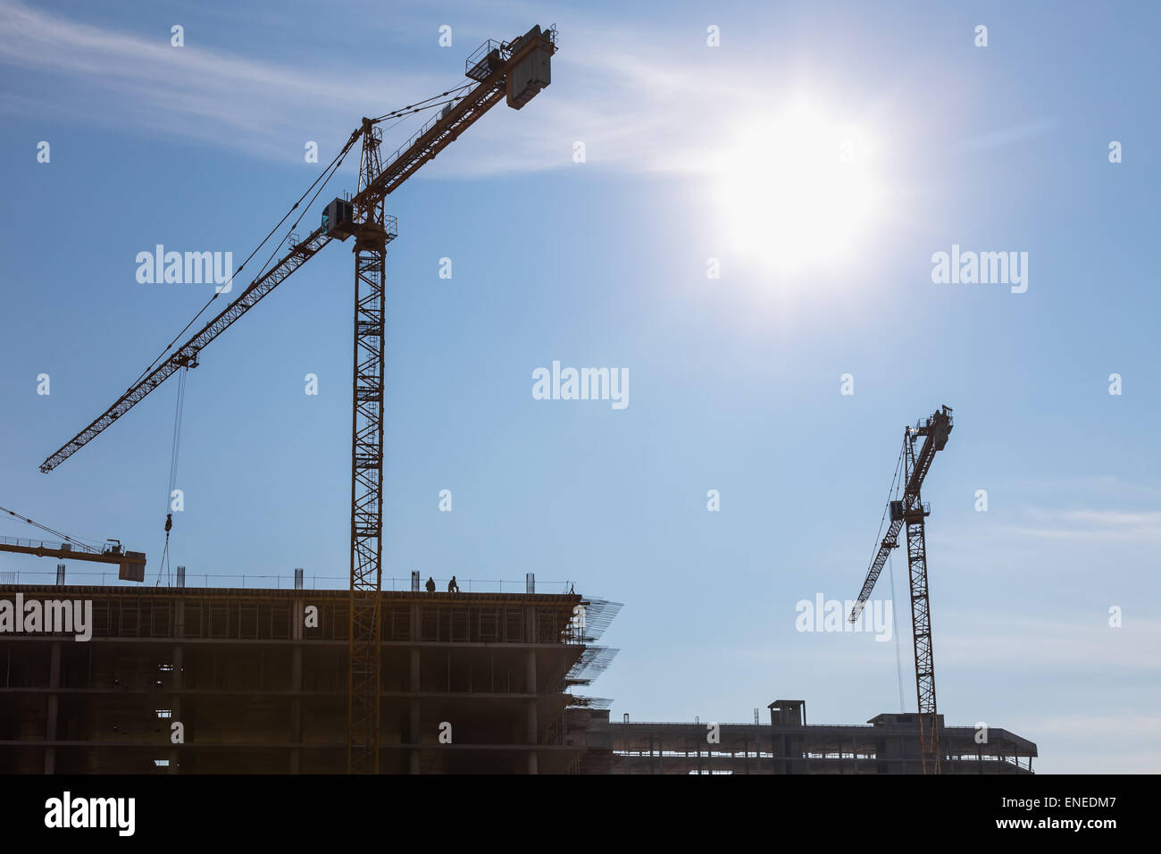 Construction cranes on building site on sky background Stock Photo - Alamy