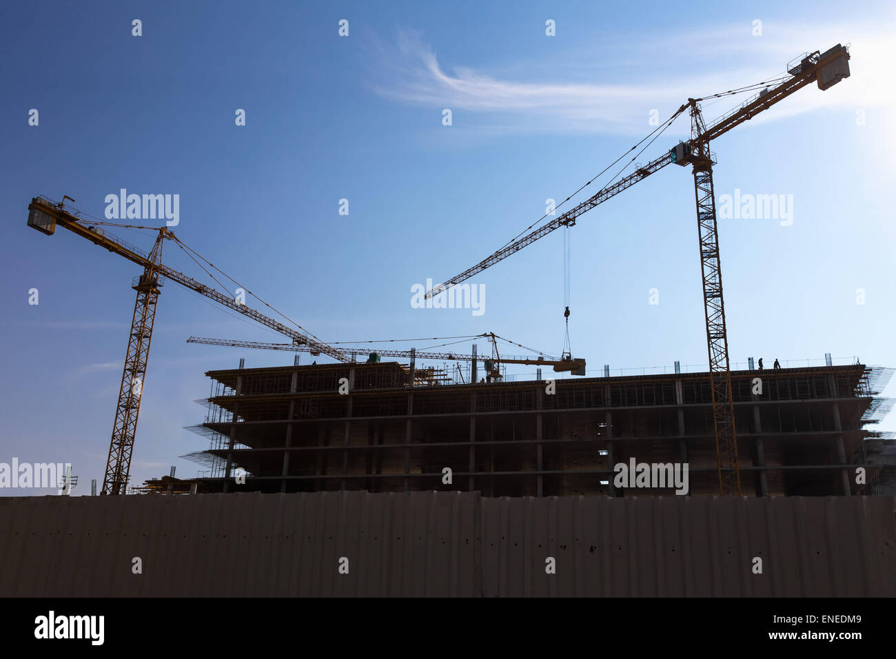 Construction cranes on building site on sky background Stock Photo - Alamy