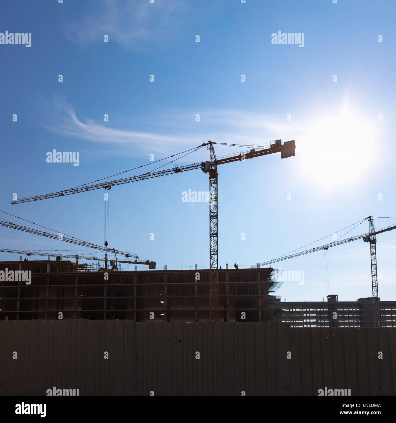 Construction cranes on building site on sky background Stock Photo - Alamy