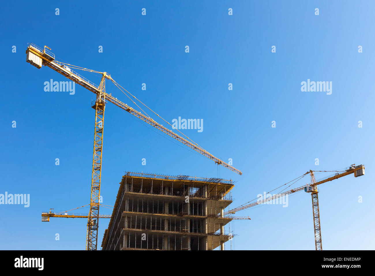 Construction cranes on building site on sky background Stock Photo - Alamy