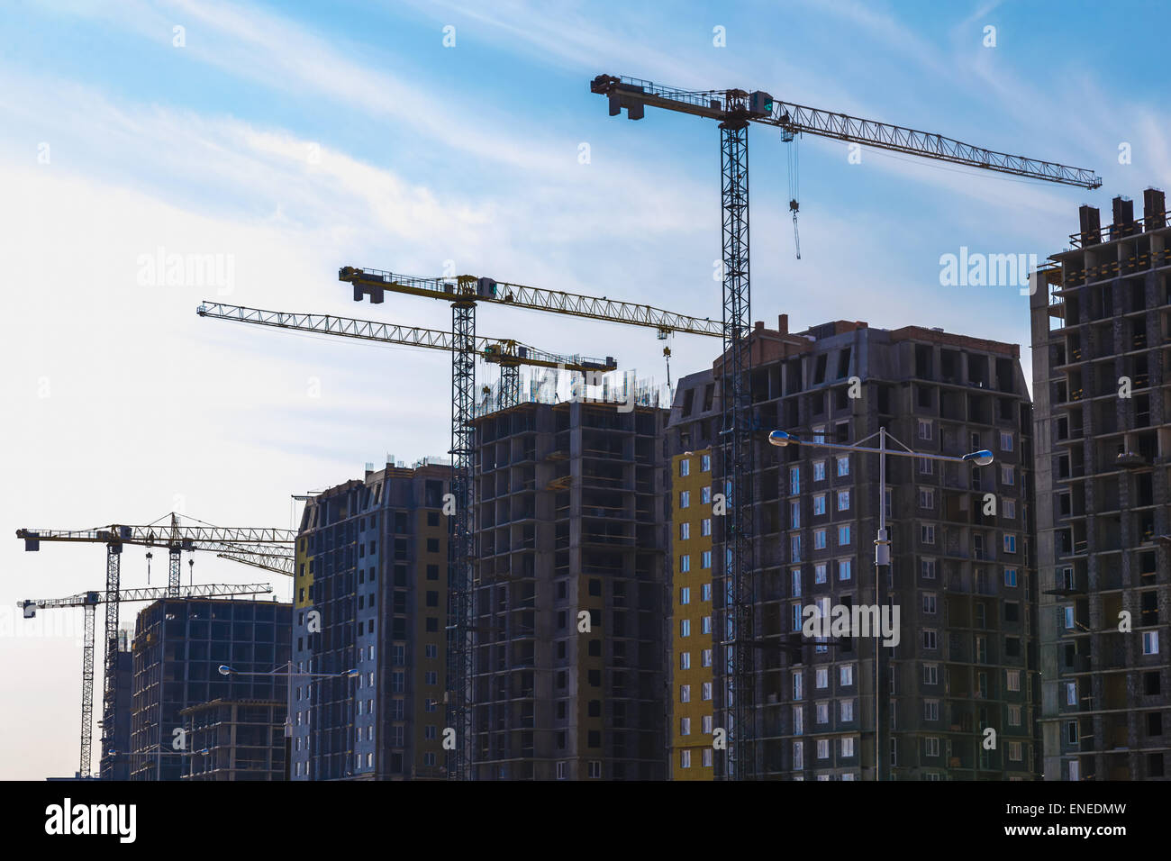 Construction cranes on building site on sky background Stock Photo - Alamy