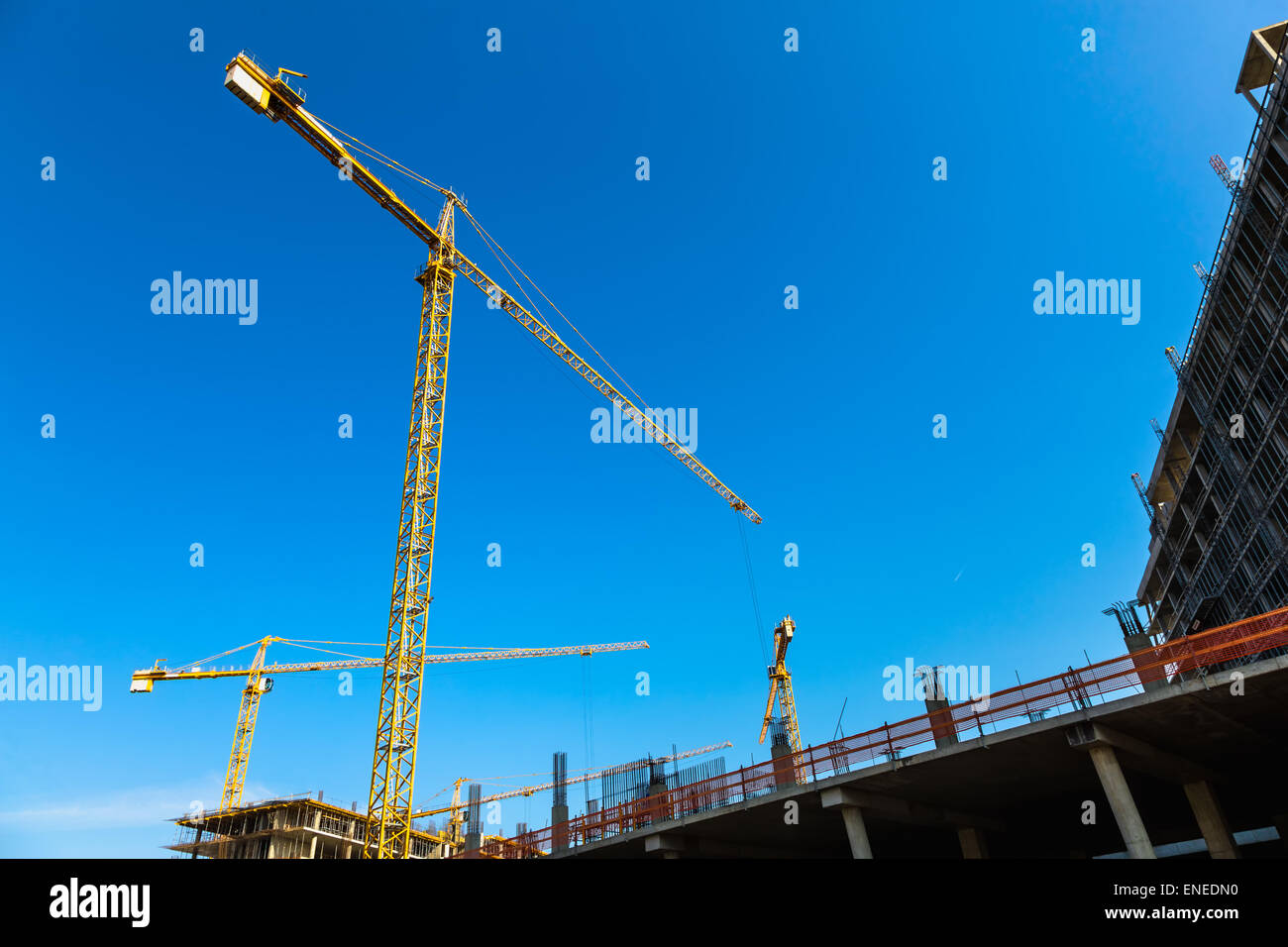 Construction cranes on building site on sky background Stock Photo - Alamy