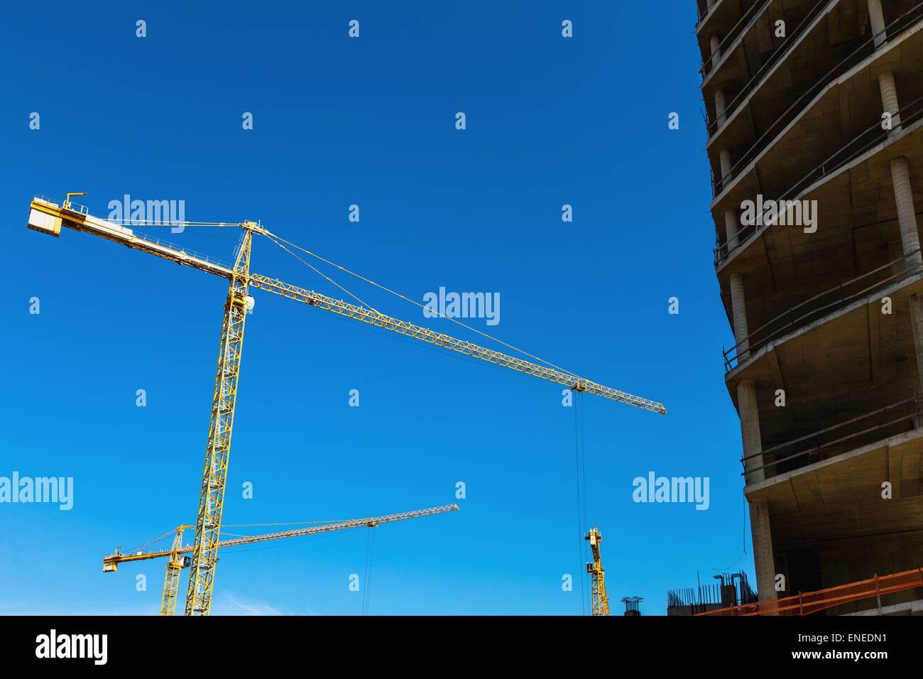 Construction cranes on building site on sky background Stock Photo - Alamy