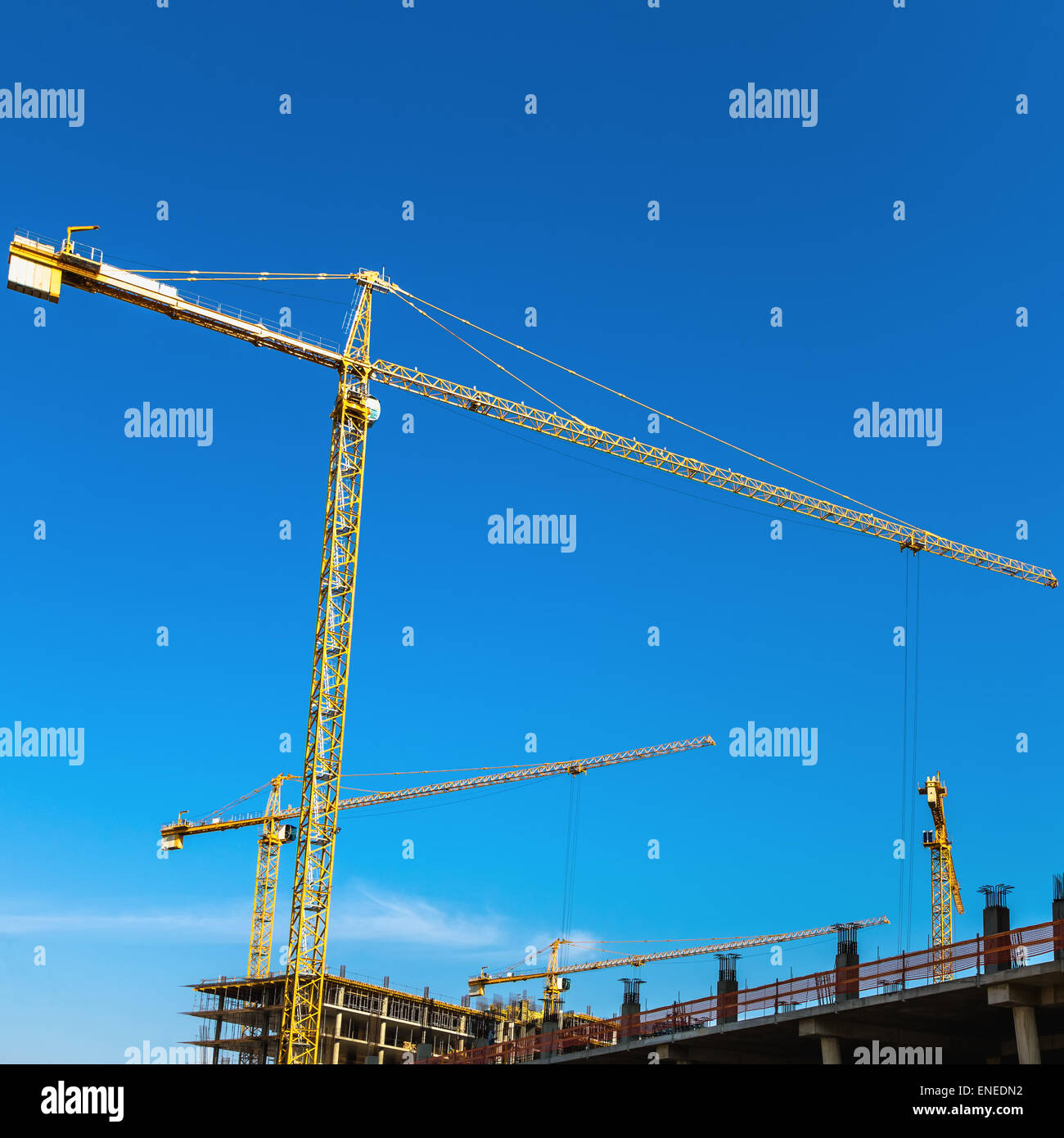 Construction cranes on building site on sky background Stock Photo - Alamy