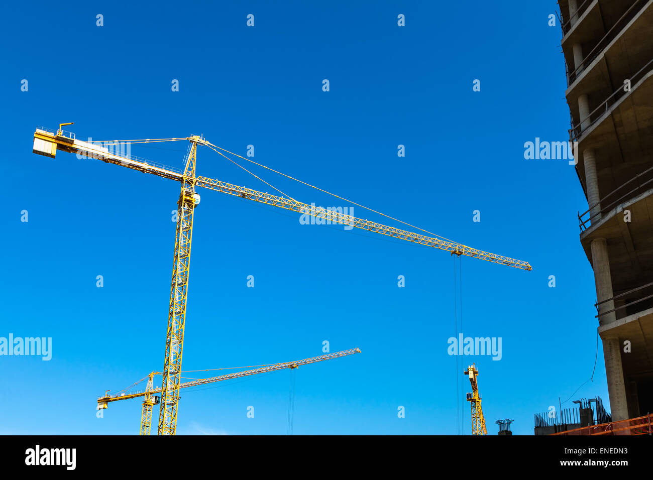 Construction cranes on building site on sky background Stock Photo - Alamy