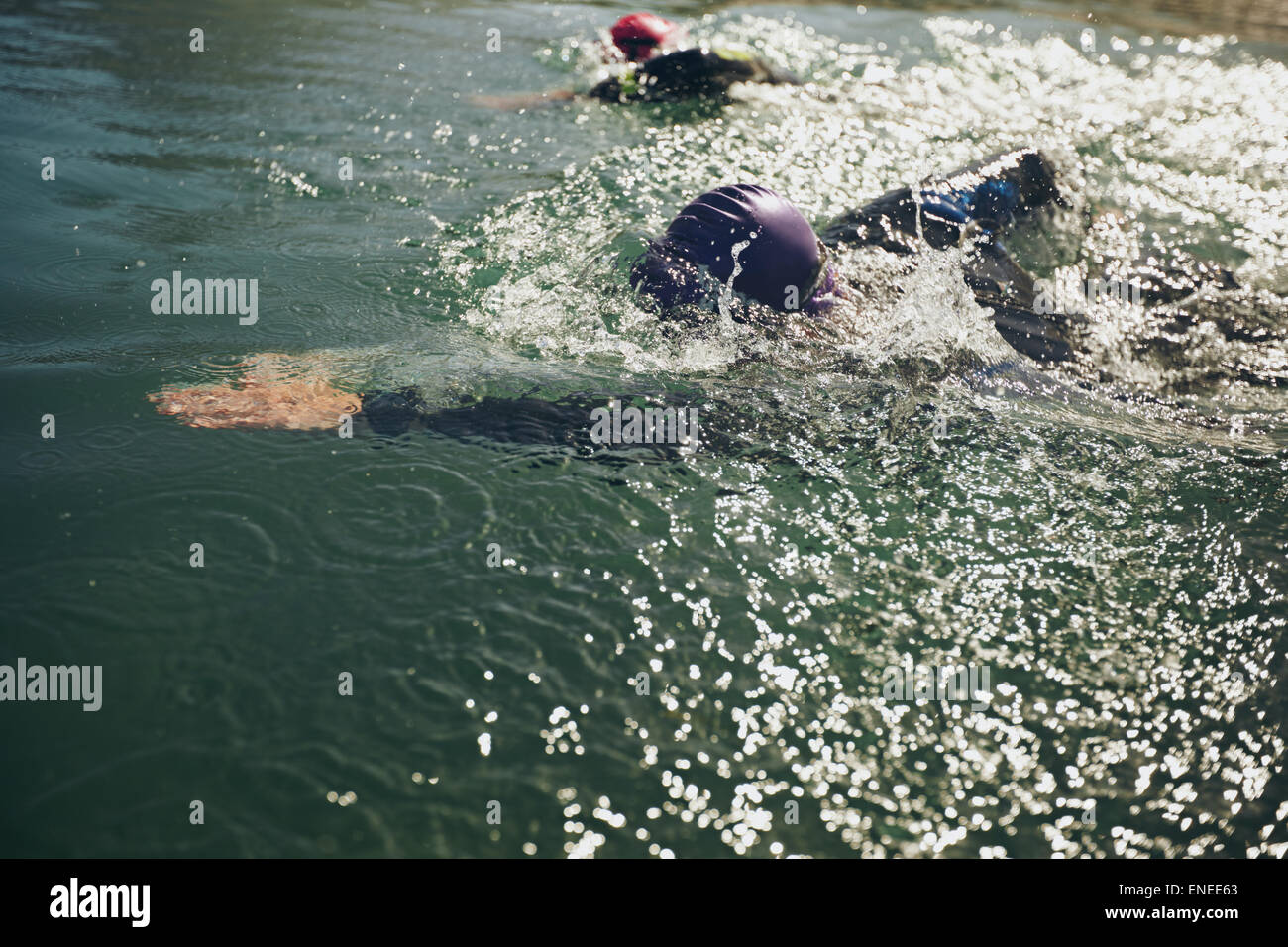 Athletes swimming in a competition. Open water swimming, athletes swimming long distance. Stock Photo