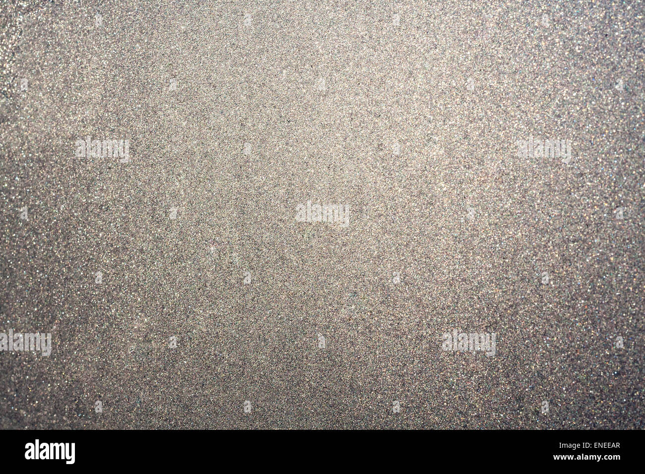 Abstract glittering silver or gray dust or sand background with blur edges of image Stock Photo