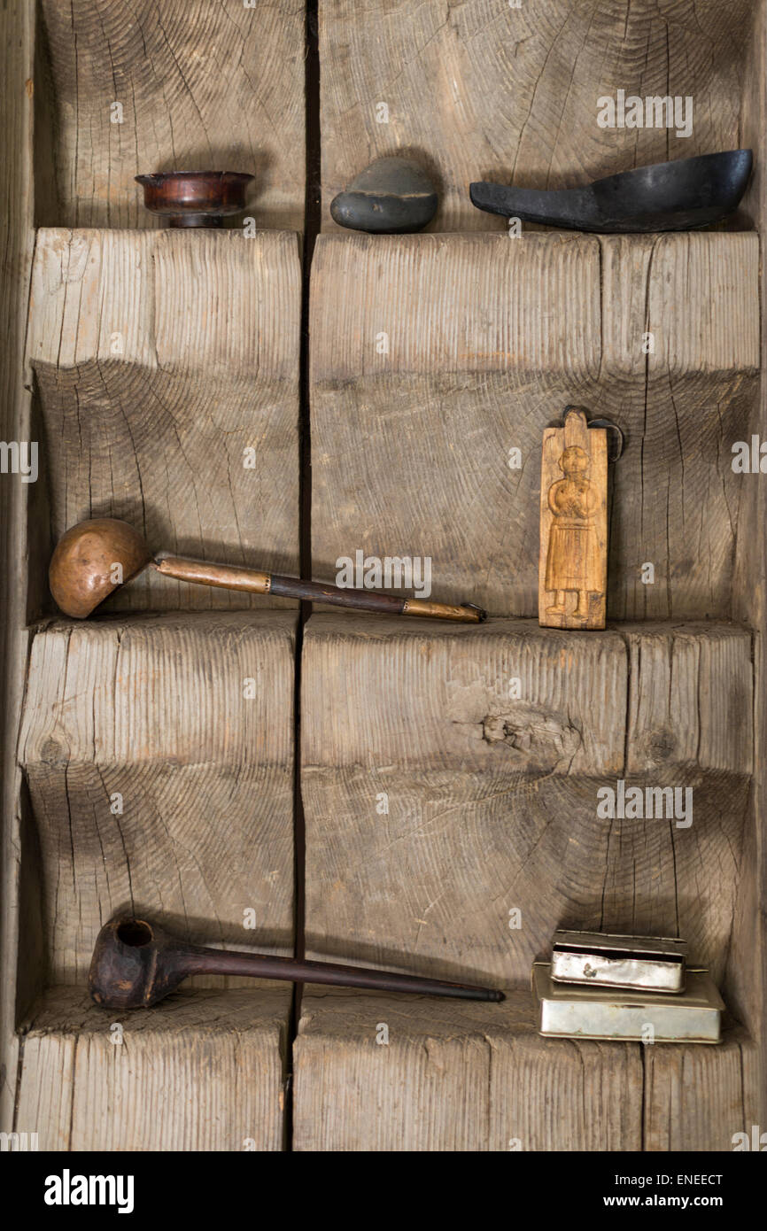 Carved wood shelf with artefacts, Wangdue, Bhutan. Asia Stock Photo