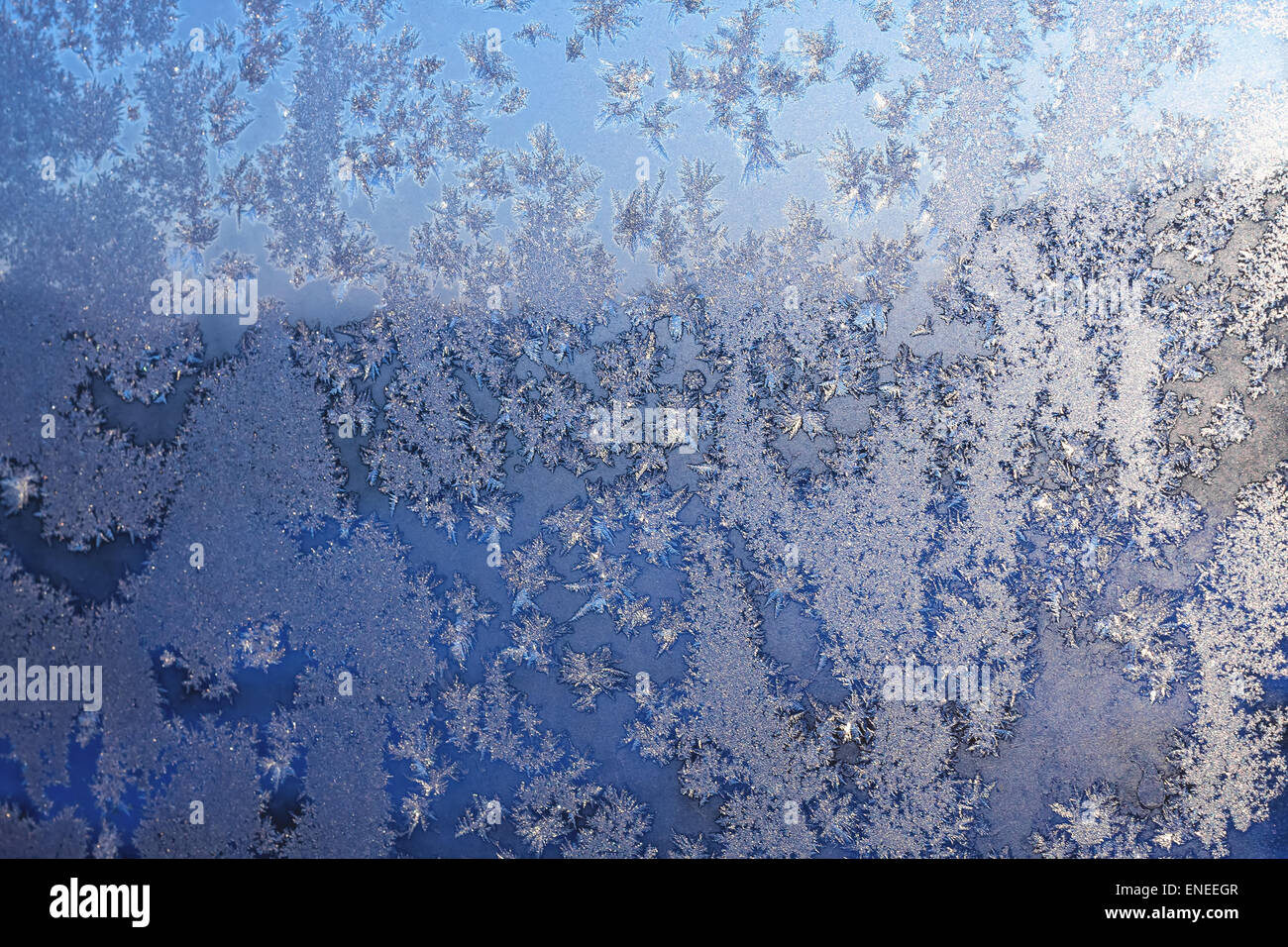 Ice snowflakes and frost pattern on Christmas winter frozen window ...