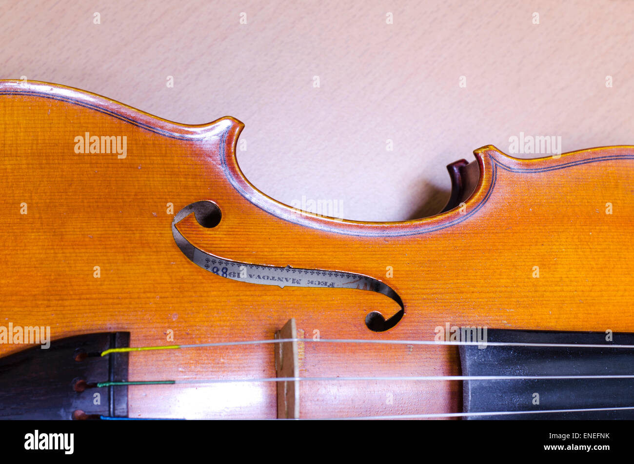 single soft brown violin with brown wallpaper Stock Photo Alamy