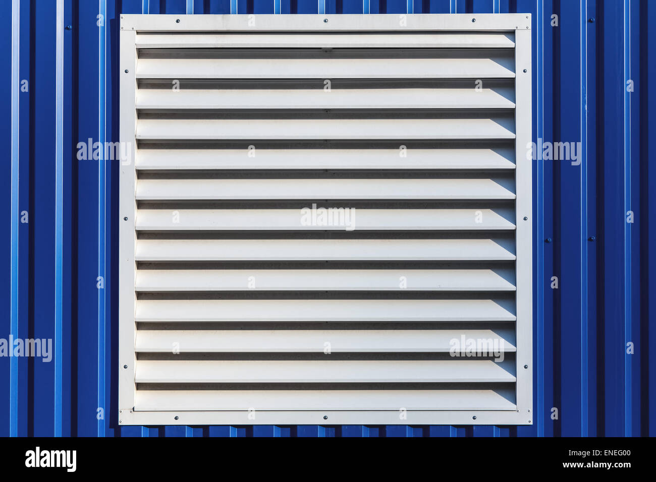 White window with jalousie in blue color metal siding wall Stock Photo