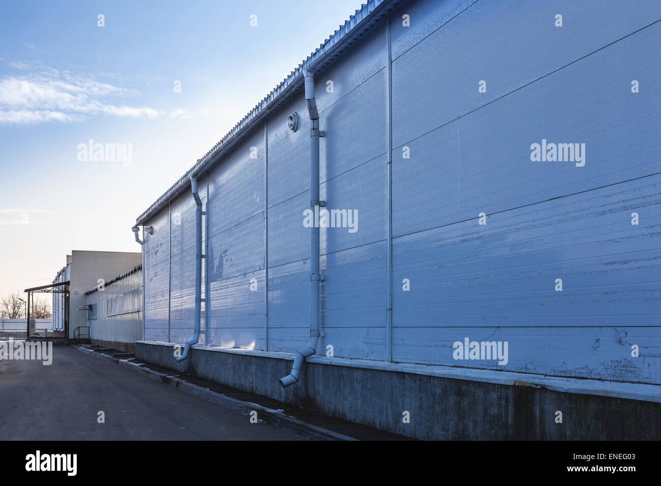 Plastic siding wall of industrial building with pipes Stock Photo