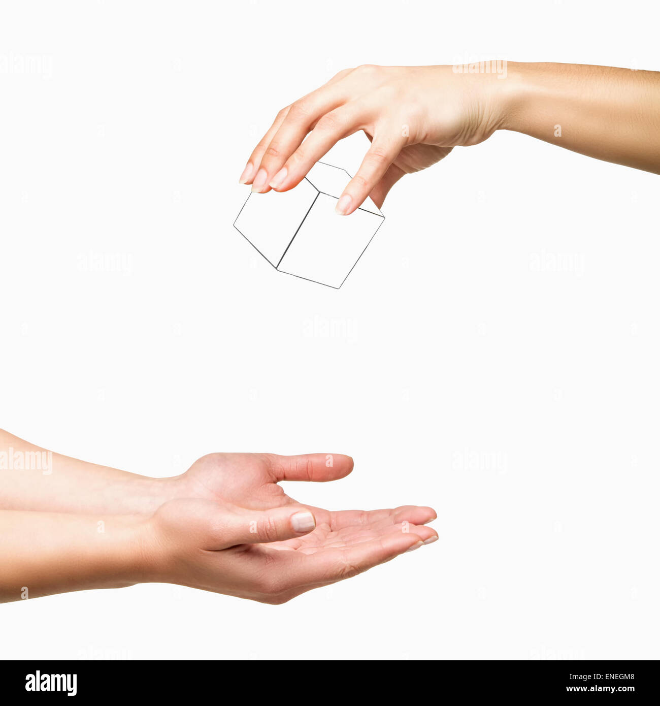 Hand holding and dropping white cube to other hand on white background Stock Photo