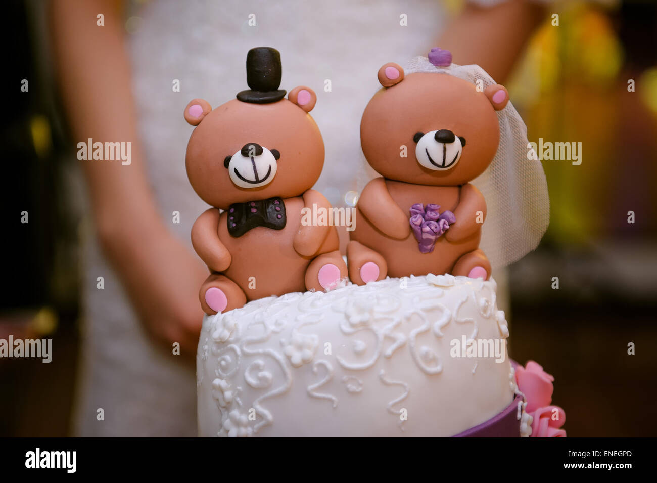beautiful wedding cake with a teddy bear at the top Stock Photo