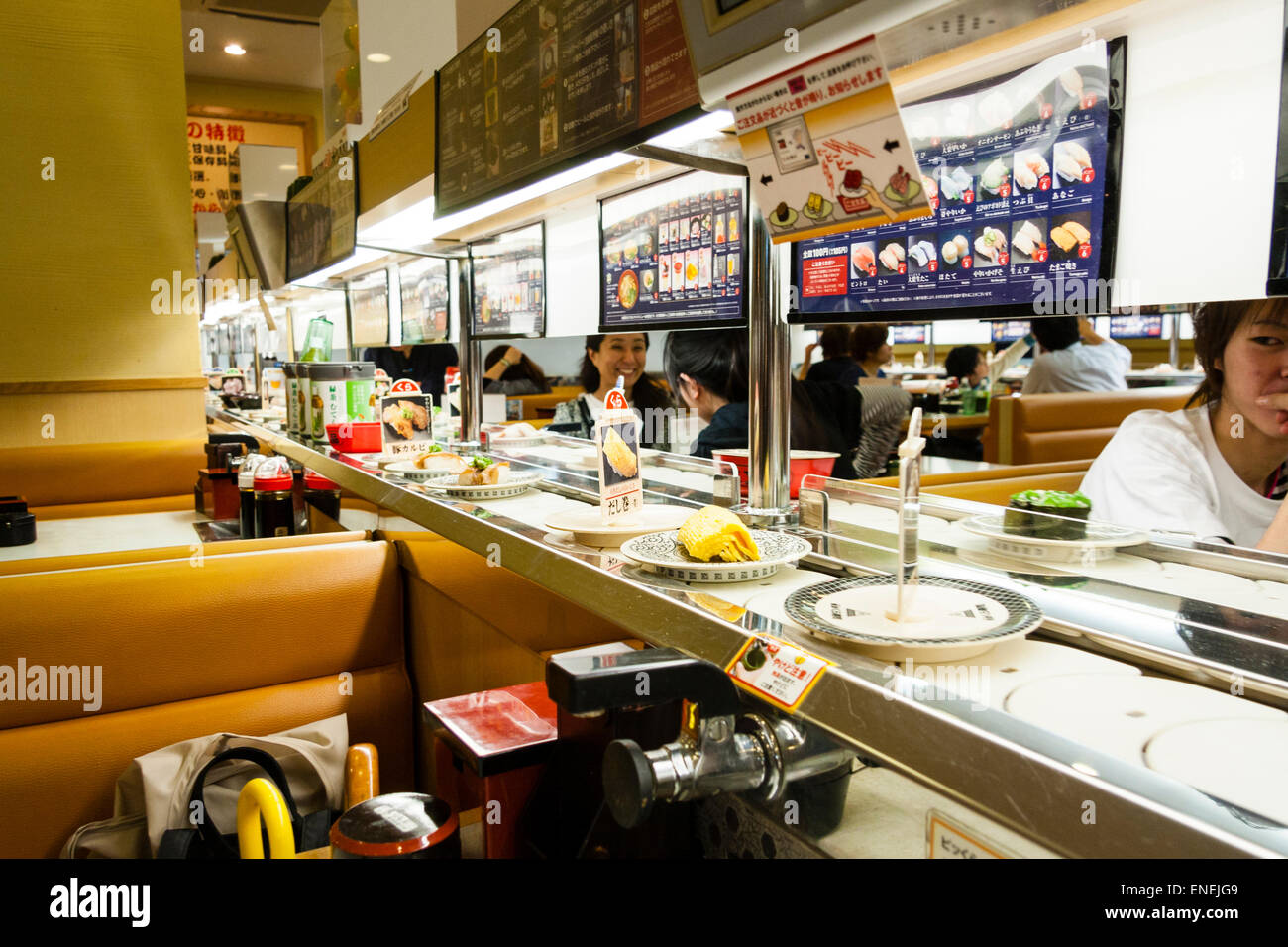 Interior of a typical Japanese conveyor belt sushi restaurant. Close up of various sushi and