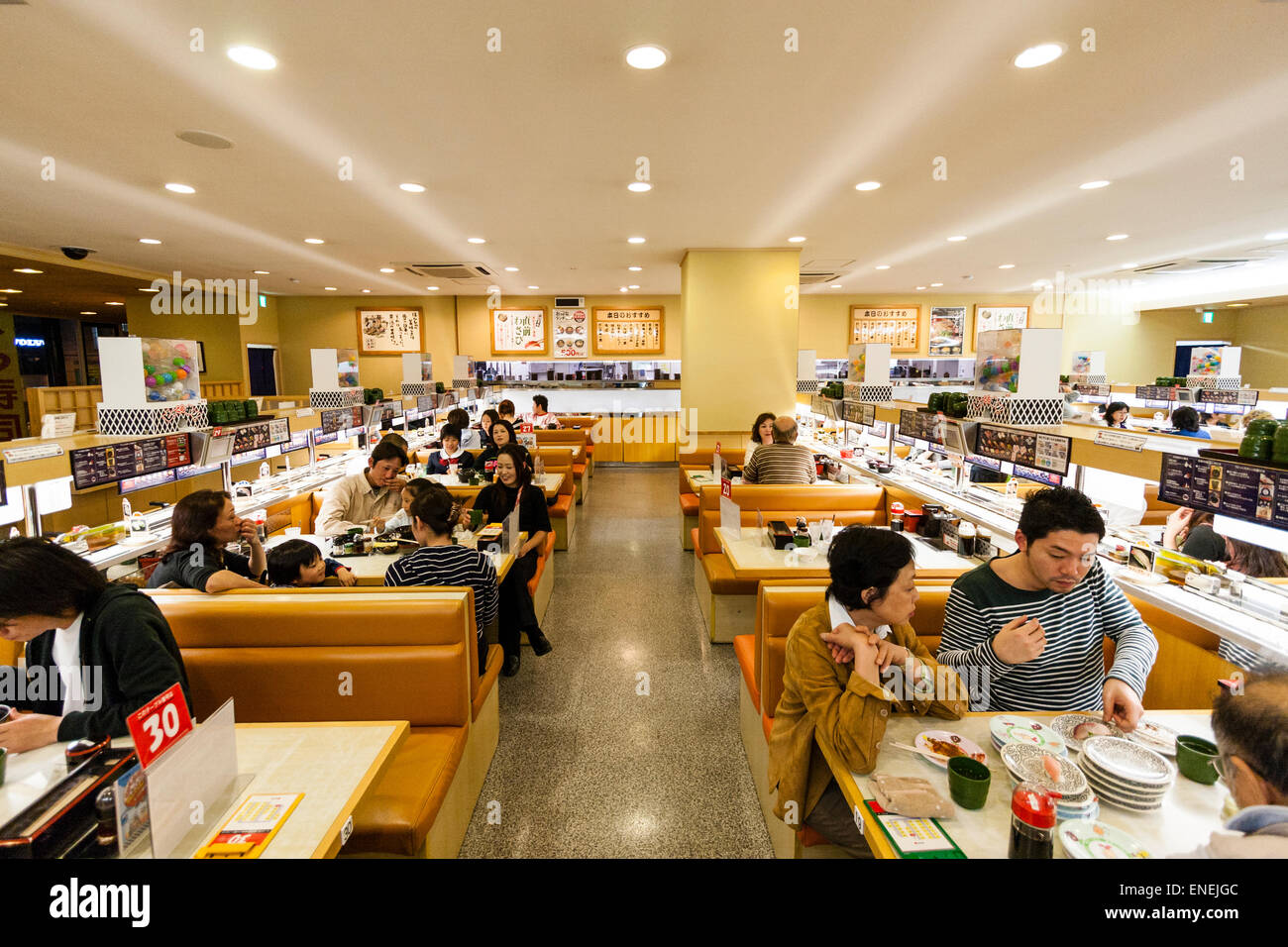 Japan, Nishinomiya. Interior, conveyor belt sushi restaurant. People