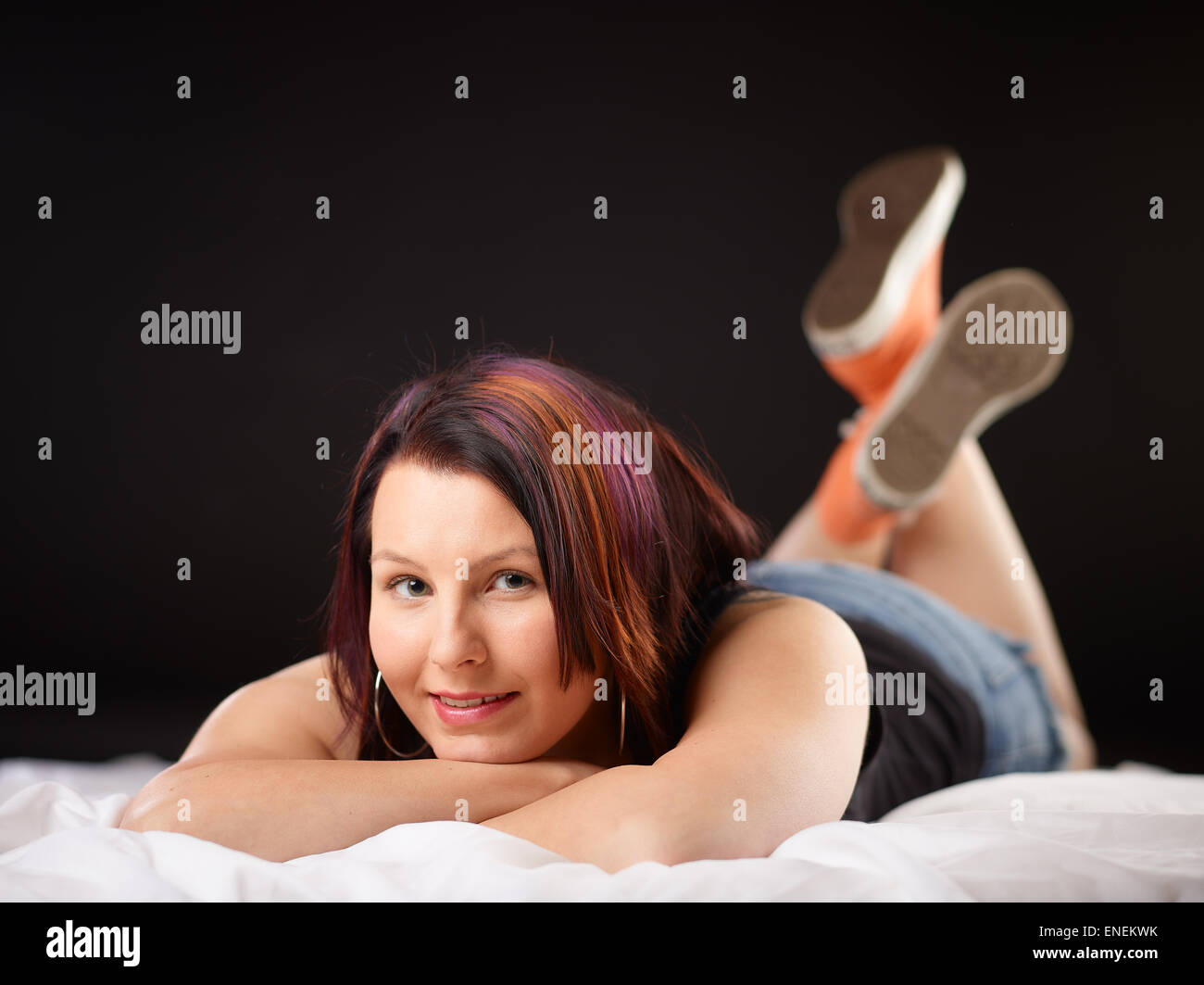 Girl on bed and sneakers Stock Photo