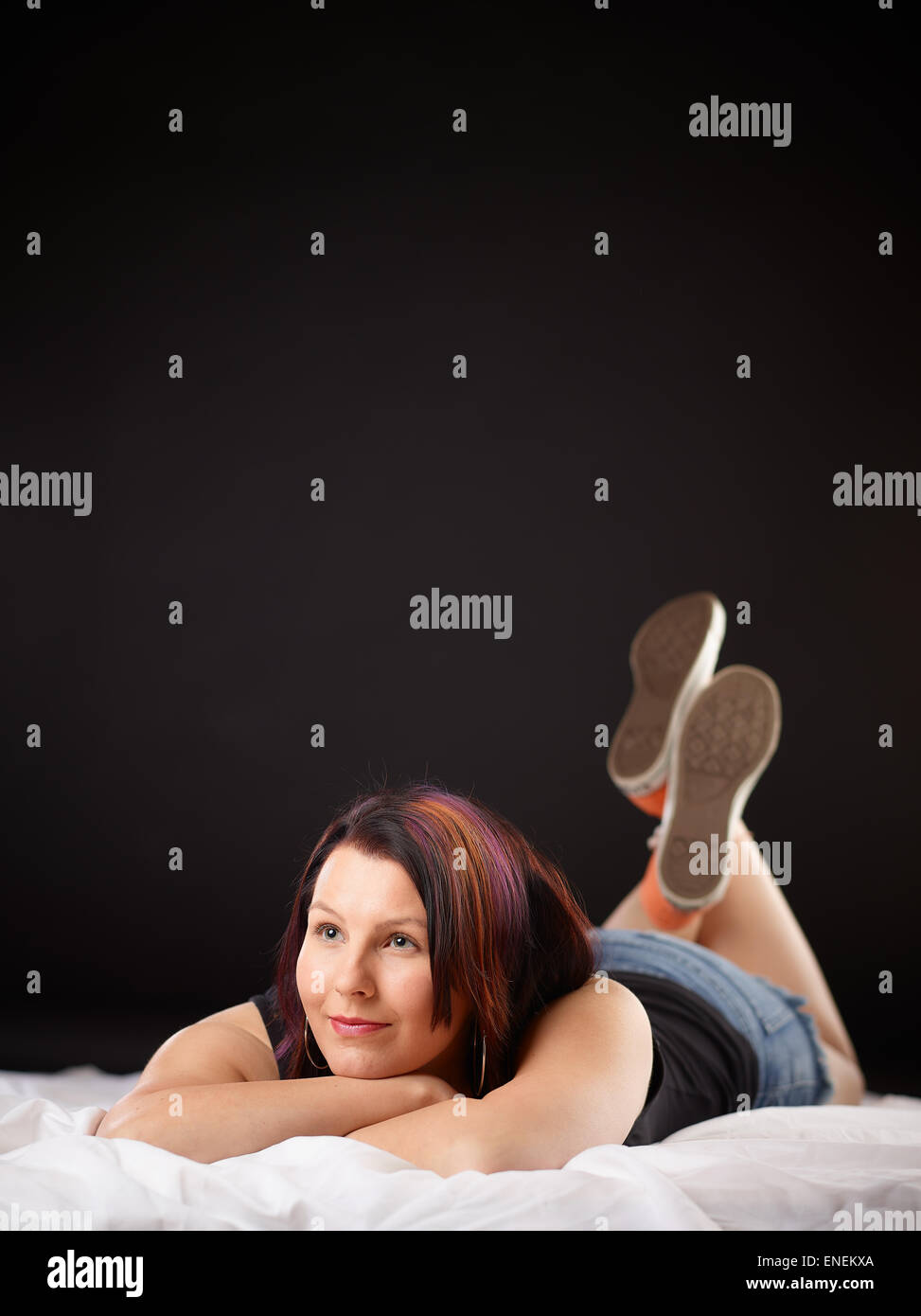 Girl on bed and sneakers Stock Photo