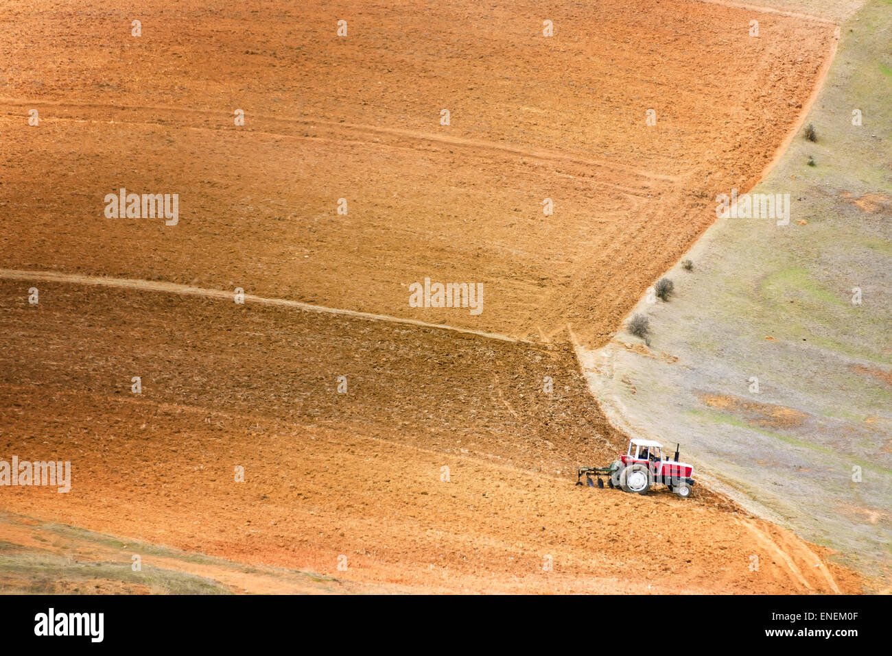 Tractor plowing a large field near Concepcion, Peru Stock Photo