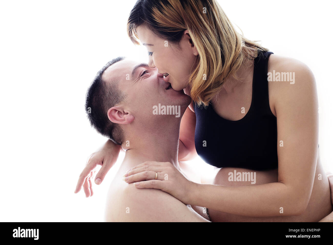 Beautiful future parents: his pregnant Asian wife and a happy husband with new life for family complete Stock Photo
