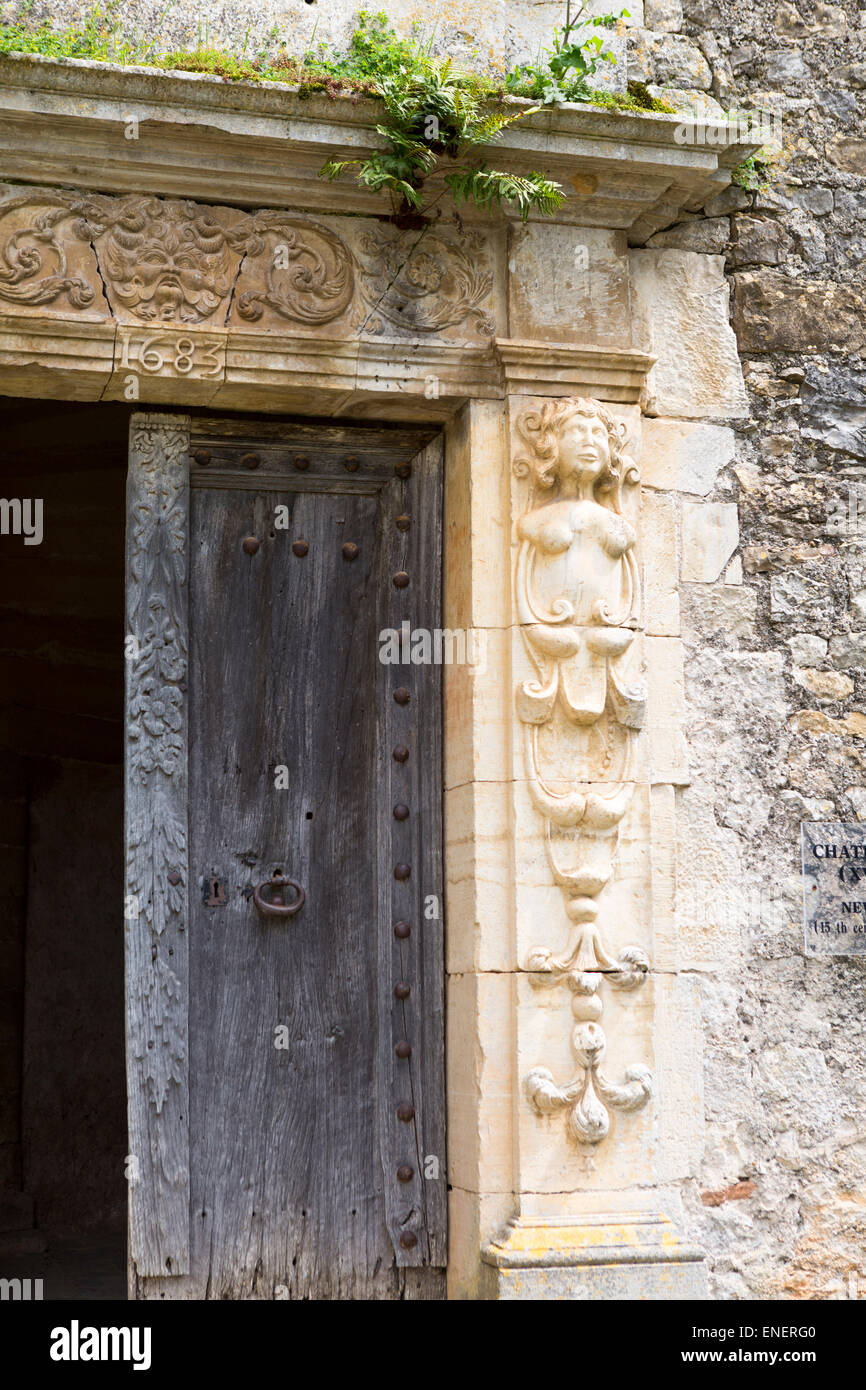 Old historical wooden door (17th century) with sculptures and ornaments at castle Bruniquel in the Midi-Pyrenees, France Stock Photo