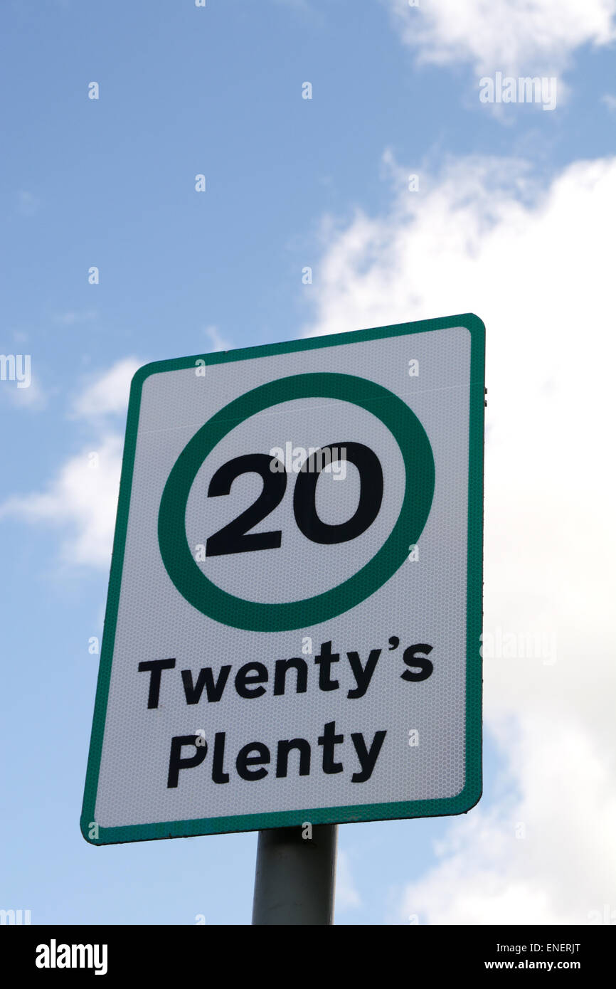 Twenty's plenty road sign against blue sky with white clouds on a sunny ...