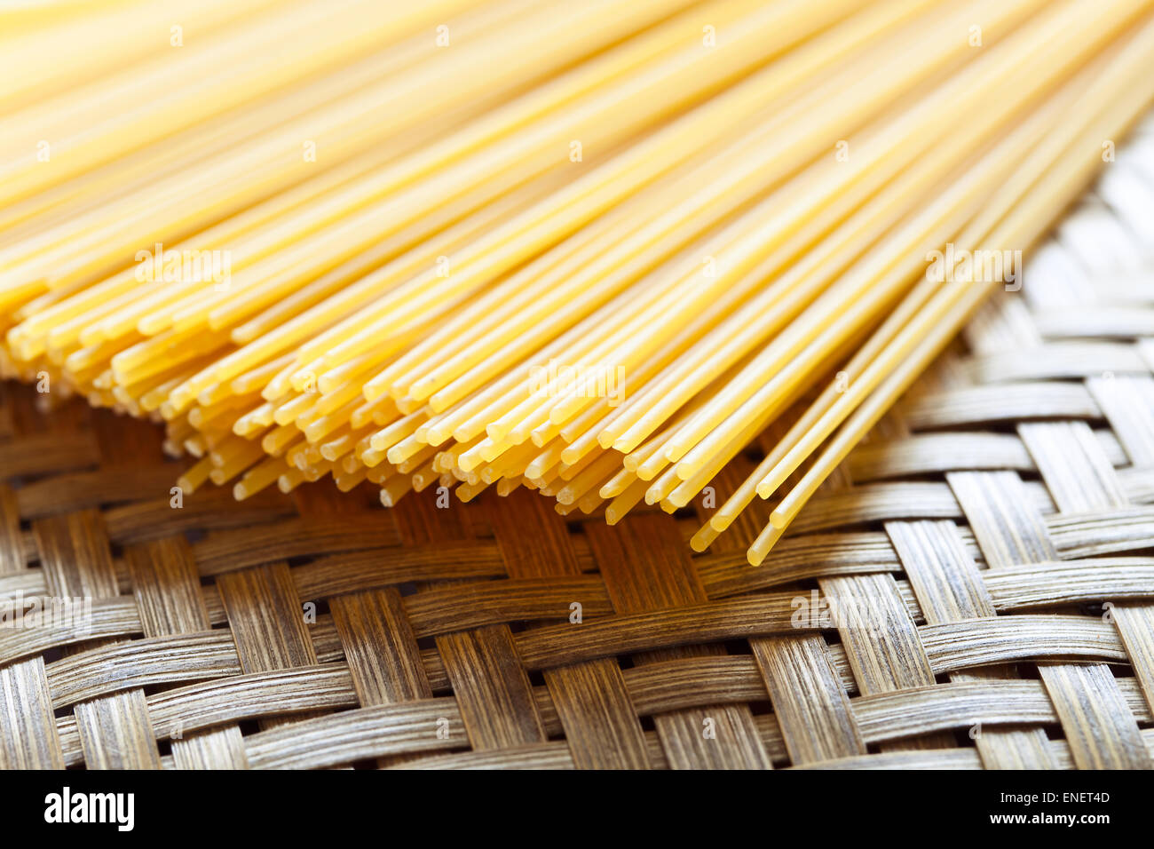 uncooked spagetti in basket , focus on center Stock Photo