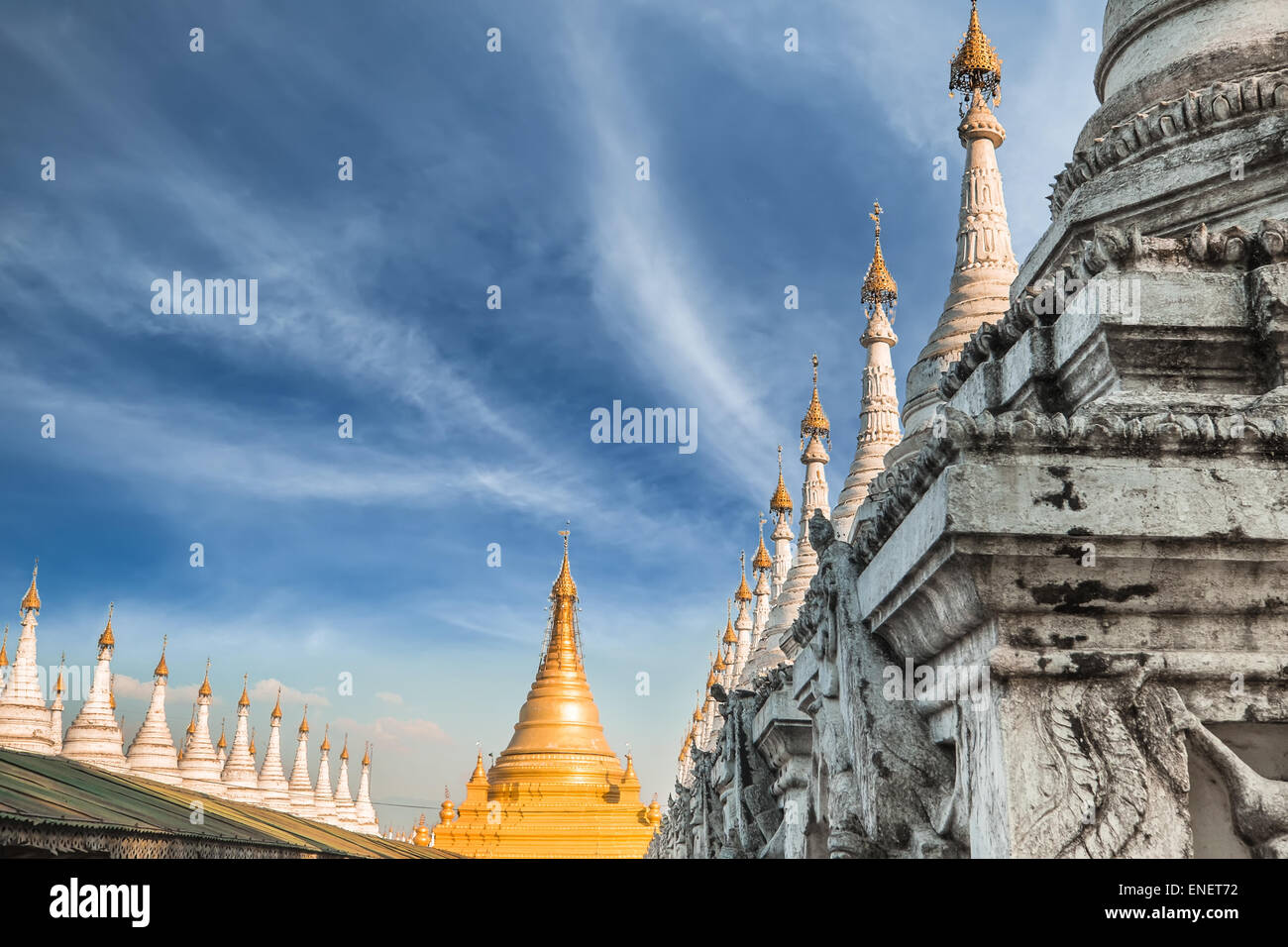 Golden Sandamuni Pagoda with row of white pagodas. Amazing architecture of Buddhist Temples at Mandalay. Myanmar (Burma) travel Stock Photo