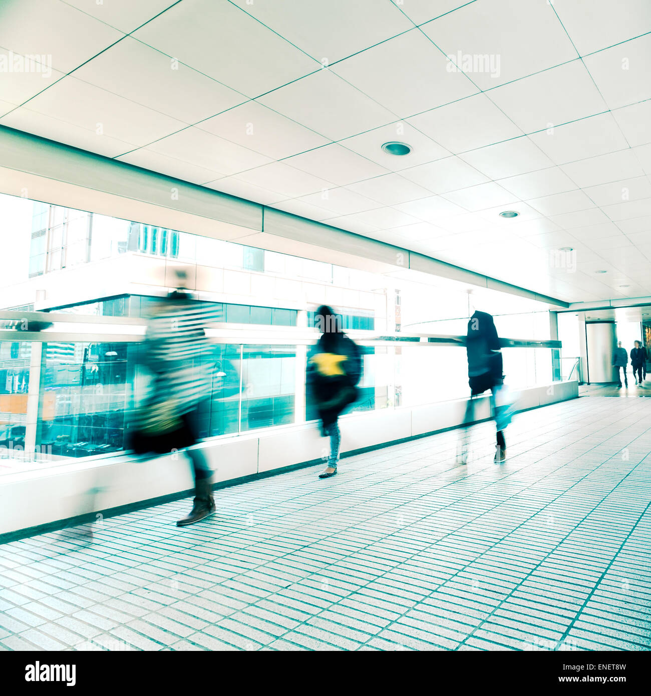 Abstract city background. Blurred image of people moving in tunnel at crowded street. Hong Kong. Blur effect, vintage style toni Stock Photo