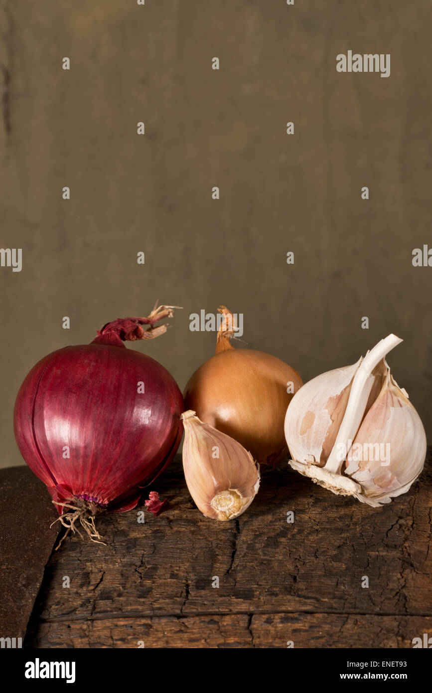 garlic and onion on the old wooden table Stock Photo - Alamy